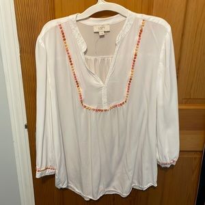 Loft outlet white blouse with peach and orange embroidered around the front.
